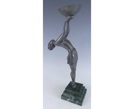 An Art Deco period cast Art Metal lamp base, modelled as a balletic semi-nude woman with her arms raised and holding a bowl, 