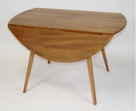 A 1960s Ercol light elm dropflap kitchen table, having opposing fall leaves, raised on slightly curved tapering supports, h.7