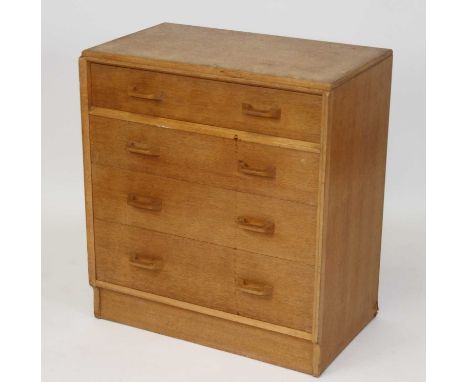 Ernest Gomme for G-plan - a 1960s light oak chest, of four long graduated drawers having curved integral handles, stamped to 