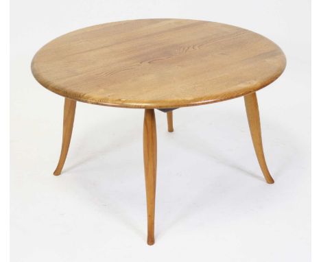 A 1960s Ercol elm circular low coffee table, raised on turned slightly swept tapering supports (re-finished as previously a d