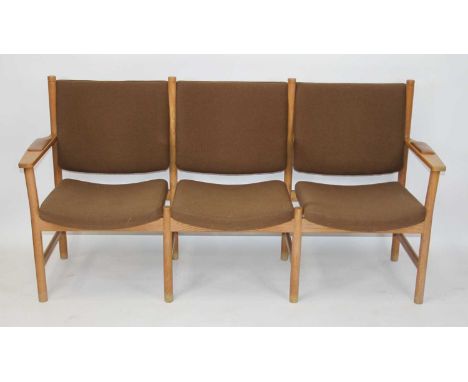 Kurt Østervig (1912-1986) - a 1960s Danish light oak framed three-seater waiting room bench, having tan leather inset arm res