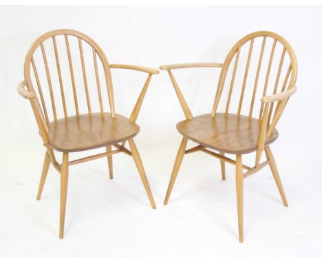 A pair of Ercol light elm stickback elbow chairs, each on turned slightly tapering supports, w.62cm Each structurally very so