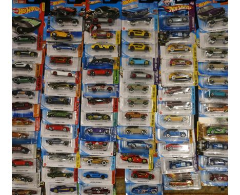Approximately seventy-five Mattel Hot Wheels diecast model vehicles, each carded. ref#Box10 (75) 