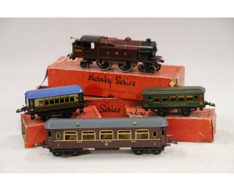 Hornby O gauge tinplate clockwork 4-4-2 tank locomotive 2180 LMS maroon boxed, a first class saloon coach 402 LMS boxed, a Pu