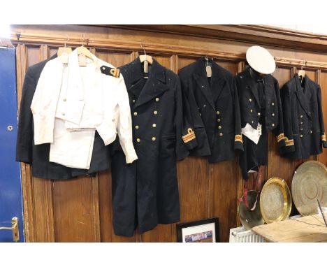 Naval uniform including a black overcoat, jackets, ness dress and a peaked cap. 