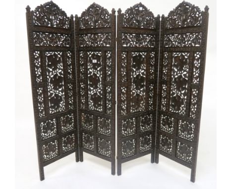 A 19th century heavily carved oak four panel room divider with foliate design carved throughout, 126cm high x 37cm wide (per 