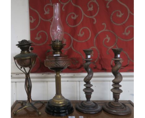 A Victorian copper &amp; brass oil lamp, brass and glass oil lamp and two oak barley twist candlesticks (4) Condition Report: