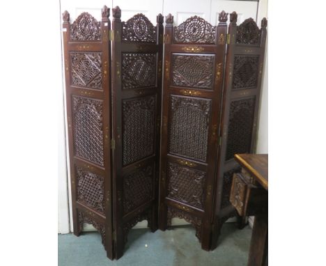 A modern carved hardwood and brass inlaid four panel room divider, 183cm high x 45cm wide (per panel) Condition Report: Avail