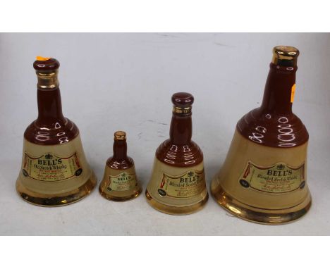 Three Bell's Scotch whisky commemorative decanters, to include Christmas 1990; together with three graduated smaller ones; a 