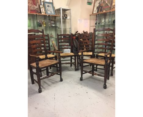 Four Ladder back chairs, two carvers and an oak table.