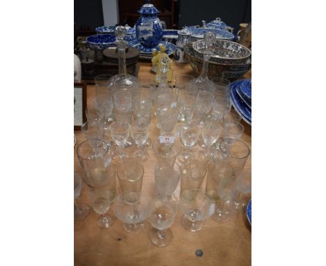 A mixed lot of vintage and antique glasses and decanters including etched examples and cut glass.