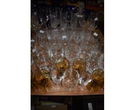 A large assortment of vintage and retro glasses and a decanter, various styles and sizes including yellow glasses with textur