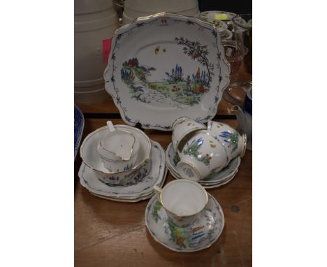 An assortment of Bell china having transfer pattern of cottage and foliage, accented with blue,red,green and yellow including