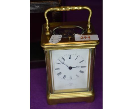 A mid 19th century brass cased carriage clock having visible escape mechanism with visible movements key and case marked for 