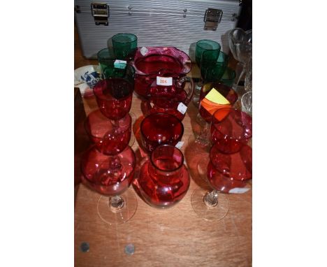 A selection of clear and cut stemmed wine glasses in Jade green and Ruby colours in fine condition