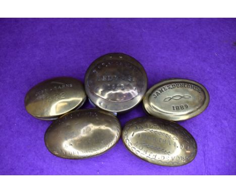Five brass cast snuff box or containers including North Devon Bedwas and Barnes