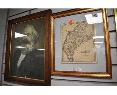 A vintage map print of Cumberland and a similar Russian print of a man
