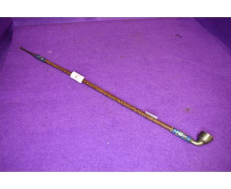 An elegant long stem opium smokers pipe with snake skin style shaft with ceramic decorated fitments