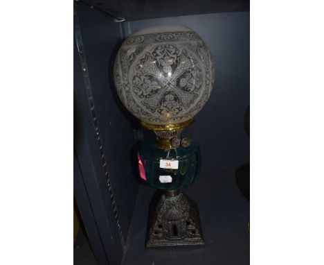 An impressive Victorian oil burning lamp having aqua blue glass well with cast iron colonial style base with etched shade
ver