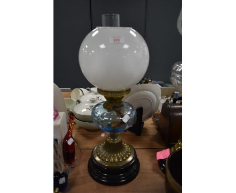 A fine Victorian oil lamp having blue glass well with brass and ceramic base