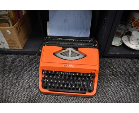 A genuine vintage typewriter by Underwood having case and orange body