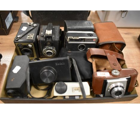 A box of various vintage cameras including Kodak Brownie, Instamatics, Coloursnap 35 and Gevabox