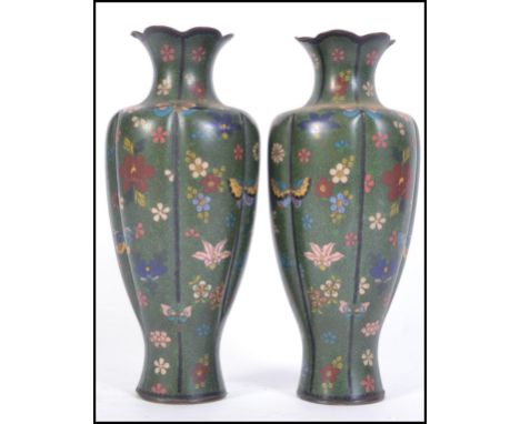 A pair of 19th century Japanese bulbous Cloisonne enamel on copper vases having a scalloped rim and decorated with flowers an