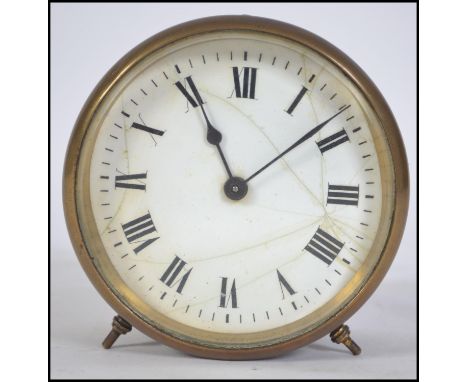 A vintage late 19th century brass circular barrel clock, having white enamelled dial with Roman numeral chapter ring, set on 
