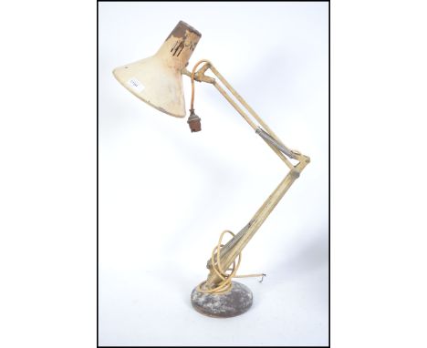 A 20th century Industrial anglepoise lamp raised on circular base with unusual stem and wide mouth pendant shade