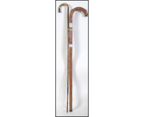 A early 20th century silver hallmarked  collared promenade cane with horn handle, brass feral, dating to 1909, together with 