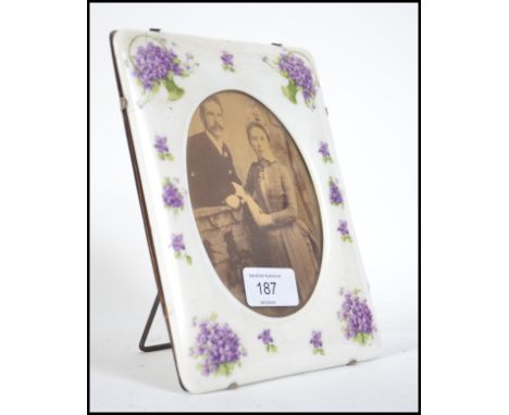 A late 19th / early 20th century ceramic hand painted easel back picture frame. Painted with baskets of flowers. Measures 20c