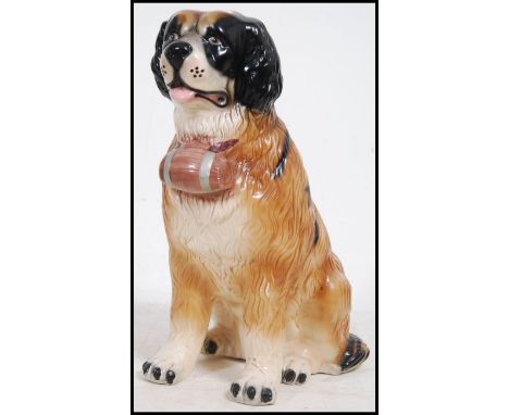 A large ceramic floor standing figurine of a St Bernards dog complete with barrel. Unsigned to base, circa 20th century. Meas