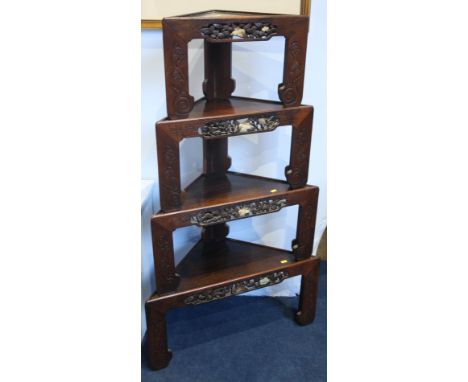A set of four Oriental hardwood stacking graduated corner tables, each with a pierced freize with mother of pearl and decorat