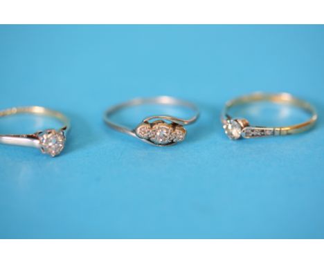 An 18ct gold solitaire diamond ring, another 18ct ring and a platinum ring. (3)