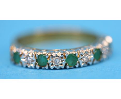 A 9ct gold half hoop eternity ring set with four emeralds and five diamonds.  Ring size N.