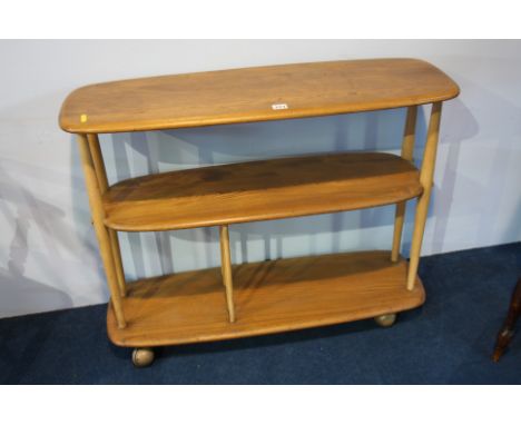 An Ercol Golden Dawn oblong three tier trolley with turned supports.