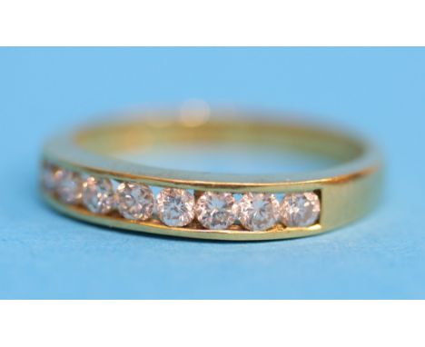 An 18ct gold Channel set ring set with 8 diamonds.  Ring size O.