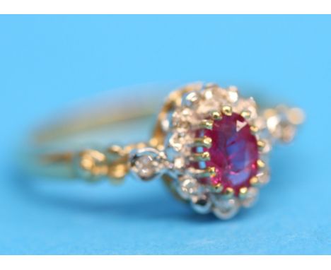 A 9ct cluster ring set with central pink sapphire with 12 small diamonds.  Ring size N.