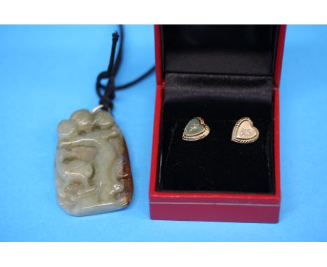A pair of 9ct gold (tested) stud earrings set with small diamonds and a carved jade pendant.