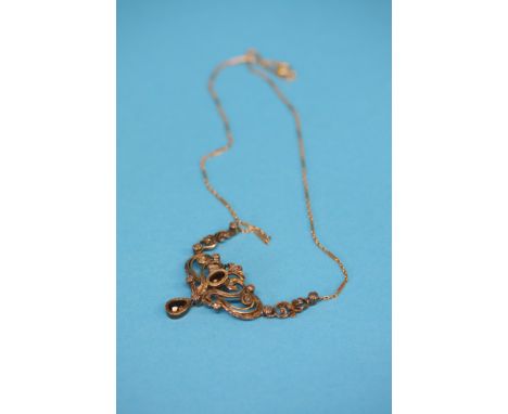 A 14ct gold ruby and diamond pendant with gold chain.