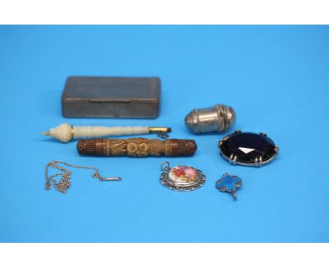Three various pendants, a snuff box, a white metal vinaigrette, a carved treen needle case and a turned mother of pearl case.