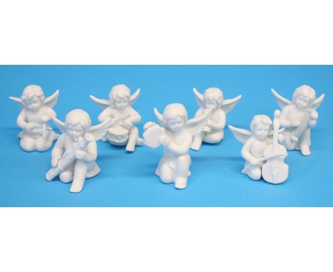 A set of seven Rosenthal classic bisque porcelain angel musicians and four Chinese Canton enamel plates.