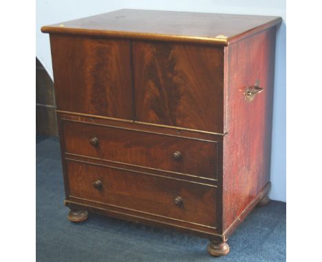 A Victorian mahogany fold over commode supported on turned feet.  66 cm wide