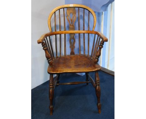 A stick back Windsor chair.