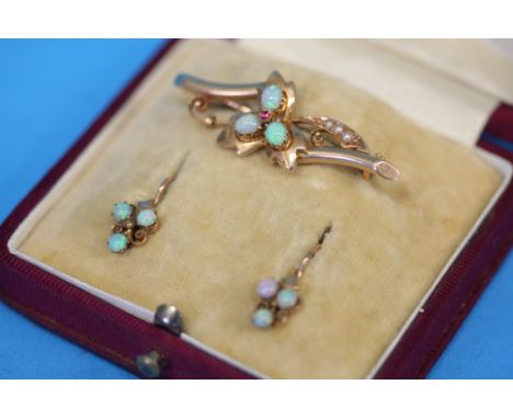 A gold pierced bar brooch set with three small opals, a pair of gold and opal earrings and a turquoise set snake ring.