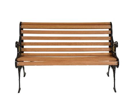 Refurbished cast iron garden bench, cast scrolled ends with mask highlighted in gilt, new hardwood slats, width 124cm, depth 