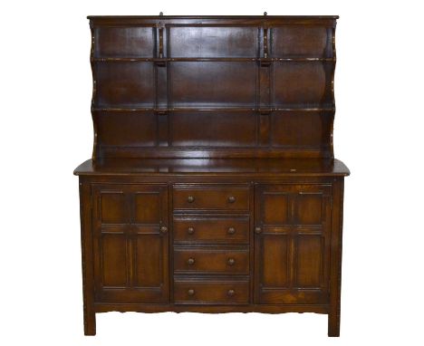 Ercol dark elm Welsh dresser, open delft rack with two shelves, the base with cupboards and drawers, width 146cm, depth 50cm,