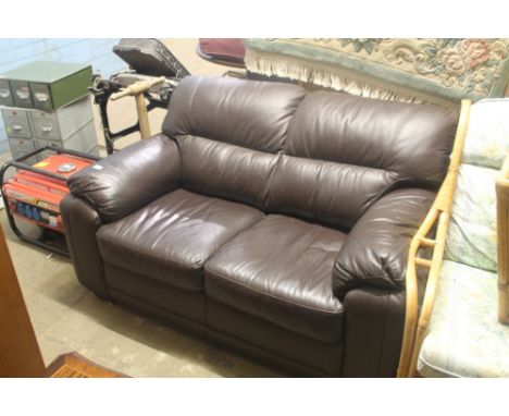 A BROWN LEATHER TWO SEATER SOFA