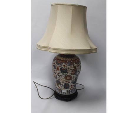 A LARGE CHINESE TEMPLE JAR CONVERTED FOR USE OF A LAMP
