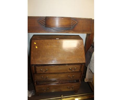 AN OAK FIRE SURROUND TOGETHER WITH A BRASS FENDER AND A BUREAU 